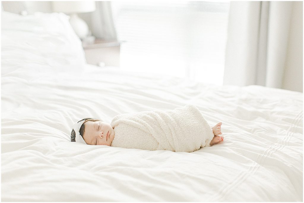 DC Newborn Photography baby girl swaddled on master bed
