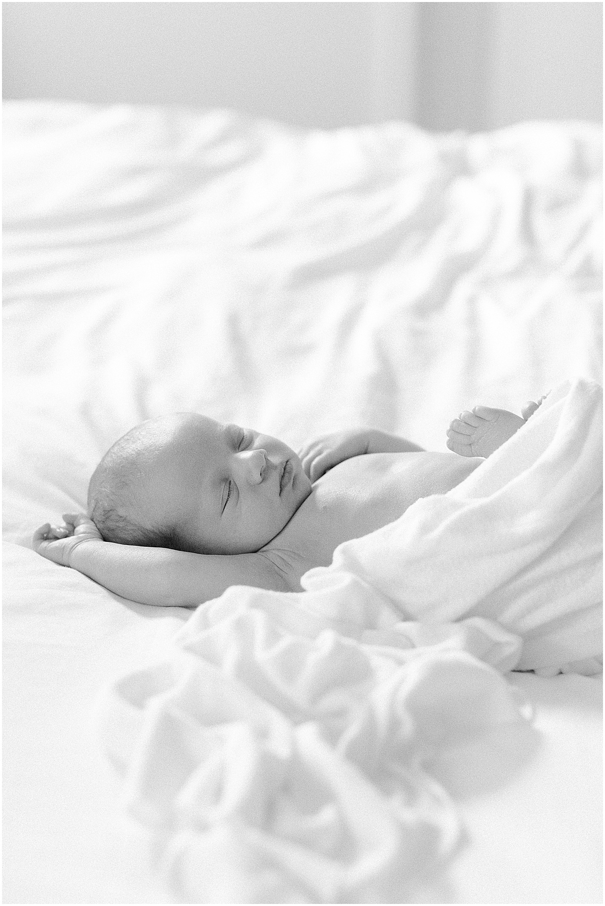 Black and white image of newborn baby boy wrapped for his in-home newborn photography session in Westminster Maryland